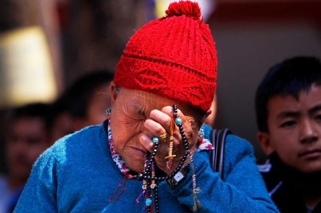 Mother of Nepalese mountaineer Ang Kaji Sherpa holds prayers beads while she waits for his body at the Sherpa Monastery in Katmandu, Nepal Photo Niranjan Shrestha/ AP