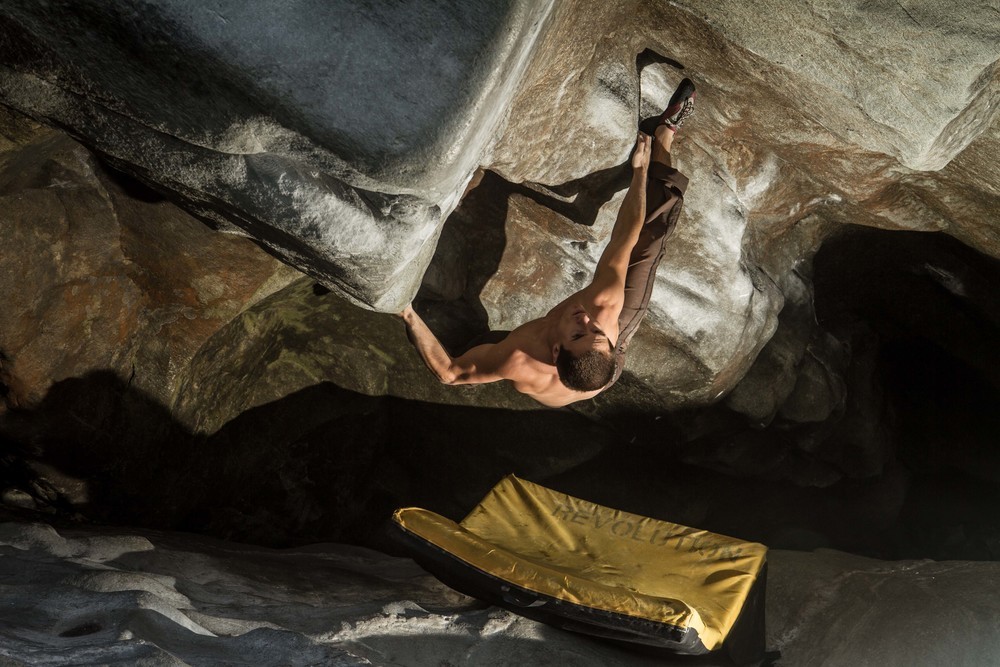 Revolution Athlete Carlo Traversi climbing The Neverending Story V14 in Magic Wood, Switzerland over a Mission Pad.