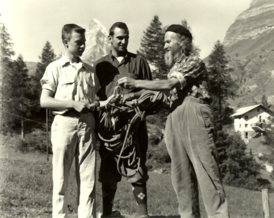 John Salathe retires from climbing and gives his gear to John Thune Jr. as John Thune Sr. looks on. Salathe had brought a group of Boy Scouts up the Matterhorn the day before. John Thune Jr. was one of the scouts and John Thune Sr. was a life long friend of Salathe's.  Photo from Yosemite Climbing Association 