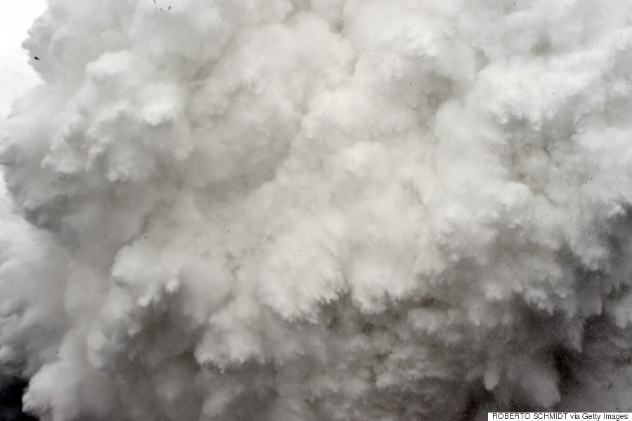 In this photograph taken on April 25, 2015, a cloud of snow and debris triggered by an earthquake flies towards Everest Base Camp, moments ahead of flattening part of the camp in the Himalayas.   Rescuers in Nepal are searching frantically for survivors of a huge quake on April 25, that killed nearly 2,000, digging through rubble in the devastated capital Kathmandu and airlifting victims of an avalanche at Everest base camp.     AFP PHOTO/ROBERTO SCHMIDT  SCHMIDT/AFP/Getty Images)