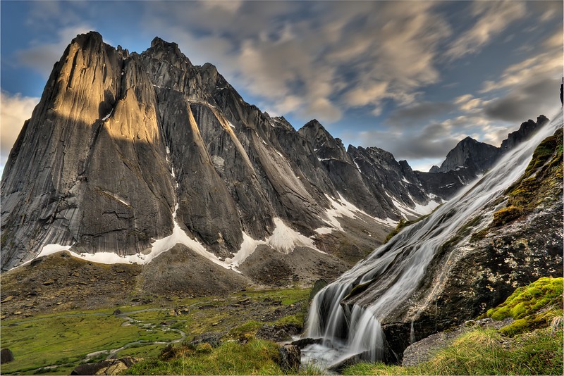 Flowing glacial creek with Mt. Harrisson Smith in the background. The Cirque of Unclimbables, a circle of granite walls, is a rock climbing mecca which draws climbers from all over the world. Nahanni National Park is one of the world's top paddling/canoeing rivers, and Unesco World Heritage site. The Nahanni River is also a Canadian Heritage River. Northwest Territories (NWT) Canada.