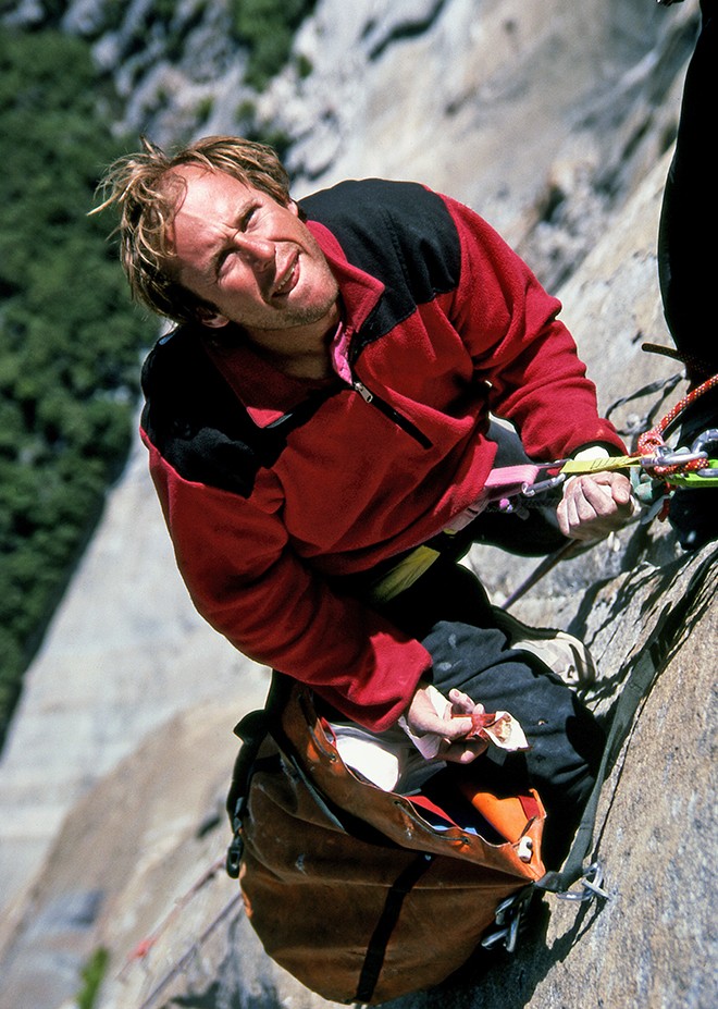 Todd Skinner eating a snickers bar at the belay on the lip of the Salathe roof. Skinner and Paul Piana made the first free ascent of Salathe Wall in 1988. Their ascent ushered in a new era of bigwall free climbing. Photo Bill Hatcher