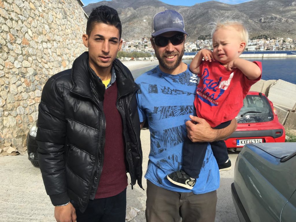 Alex Geary and his son Dax on the right with one of the refugees who had arrived in Greece.  Photo Amanda Geary