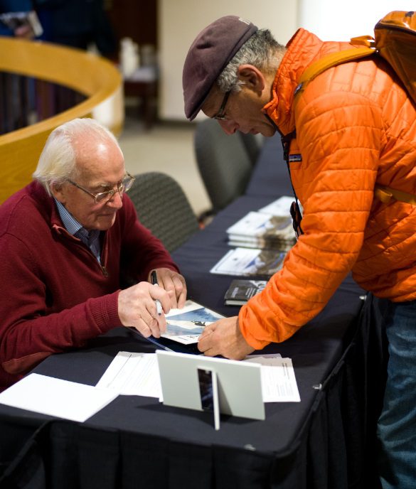 Legend Doug Scott signs a book for top climber Jack Tackle Photo