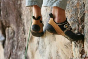 Man climbs limestone slab in La Sportiva Solution