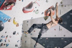 Man climbs in La Sportiva Solution on indoor climbing wall